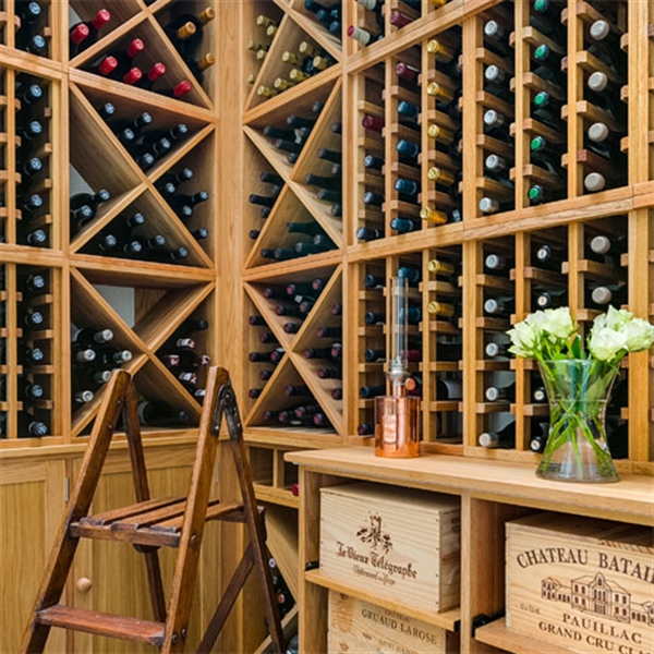 Residential compact wine cellar in oak with large glass wall in London