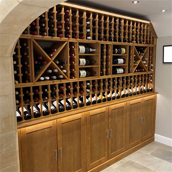 Expansive wine wall in a residential property in Northamptonshire using solid pine