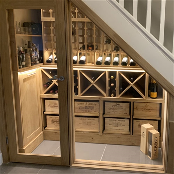 Under stairs wine room using solid pine in Oxfordshire