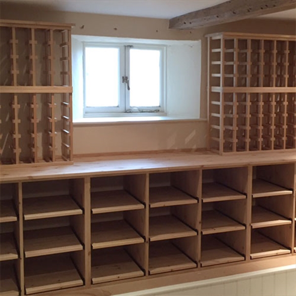 Large wine room using solid pine racking in Hampshire